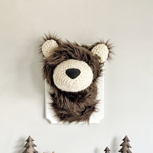 Brown Bear faux taxidermy hanging on wall. Next to tree figures and fox. Love you to moon and back framed art.