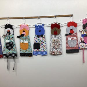 May include: A white ceramic mug with a black handle and the text "But First, Coffee" in a black, handwritten-style font. The mug is sitting on a white surface.