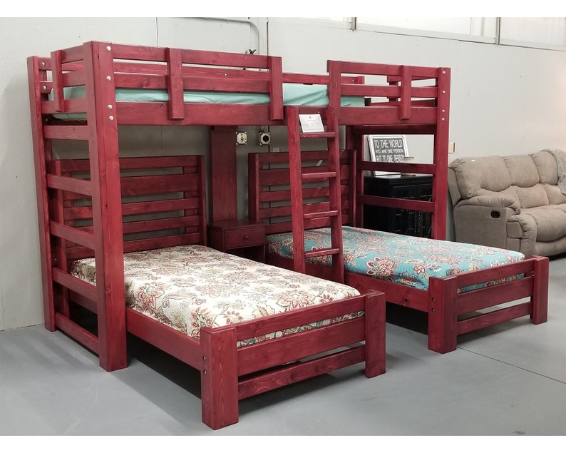 May include: A red wooden bunk bed with a ladder and a built-in shelf. The bed is made up with floral patterned bedding.