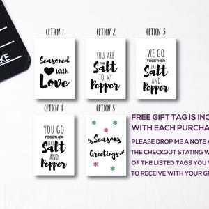 May include: Five different gift tag designs with salt and pepper themed sayings. The tags are white with black text. The designs include "Seasoned with Love", "You are the Salt to my Pepper", "We go together like Salt and Pepper", "You go together like Salt and Pepper", and "Seasons Greetings".