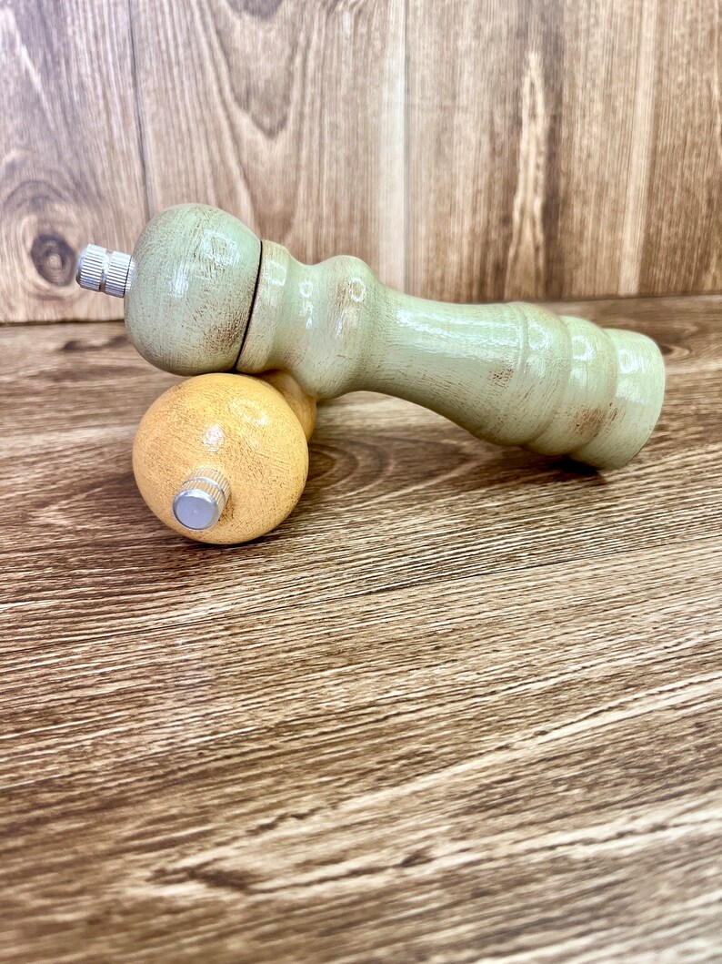 May include: A set of two wooden salt and pepper shakers. The salt shaker is yellow and the pepper shaker is green. Both shakers have a distressed paint finish.