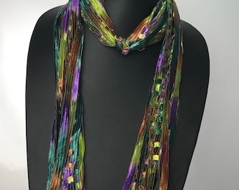 Italian Ladder Ribbon Scarf, with an array of colors-purple, rust, olive and teal green. These scarves are a great addition to any wardrobe.