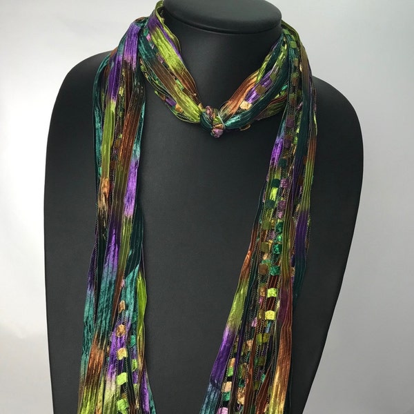 Italian Ladder Ribbon Scarf, with an array of colors-purple, rust, olive and teal green. These scarves are a great addition to any wardrobe.