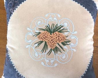 Pine cone embroidered pillow