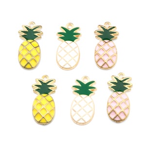 May include: Six gold-tone pineapple charms with enamel details. The pineapples are yellow, white, and pink.