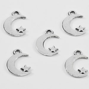 May include: Five silver crescent moon charms with a star inside each moon. The charms have a loop at the top for attaching to jewelry or other crafts.