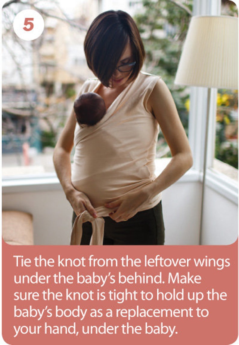 May include: A woman wearing a beige baby wrap, holding a baby. The wrap is tied around the woman's torso. The image includes the number 5 in a white circle and instructions on how to tie the wrap.