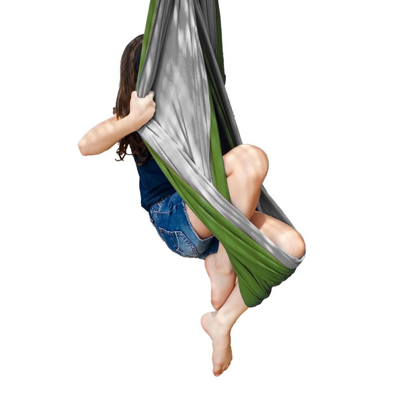 Girl swings in grey and green restNest sensory swing chair with spring suspension, indoor hammock swing, Montessori-inspired kids room decor made from soft cotton fabric for sensory regulation and cosy relaxation.