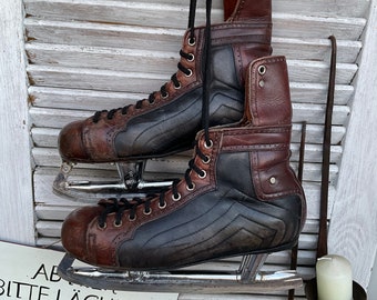 vieux patins à glace en cuir noir/marron hockey sur glace