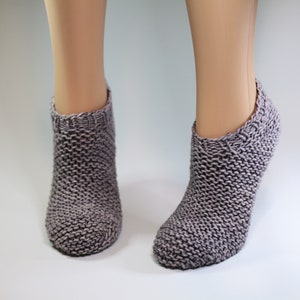 May include: A pair of gray knitted ankle socks. The socks are made with a textured stitch pattern.
