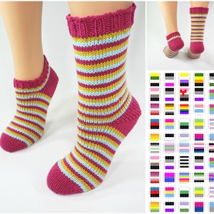 May include: A pair of striped socks in pink, yellow and blue. The socks are knitted and have a ribbed cuff.