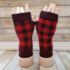May include: Red and black fingerless gloves with a plaid pattern. The gloves are knitted and have a black cuff.