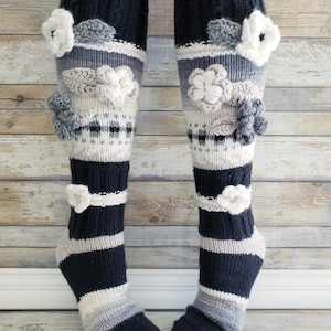 May include: Black and white striped knee-high socks with grey and white crocheted flowers.