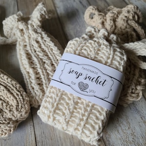May include: Three crocheted soap sacks, one with a white label that reads "Handmade Soap Sachet for you".