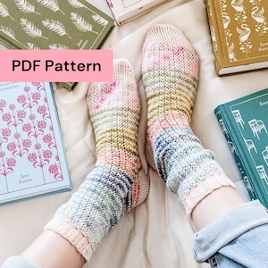 May include: A pair of hand-knitted socks in pastel shades of pink, blue, and green, are shown with several Jane Austen books. The socks have a textured pattern and are partially visible on a person's legs. The text "PDF Pattern" is visible.