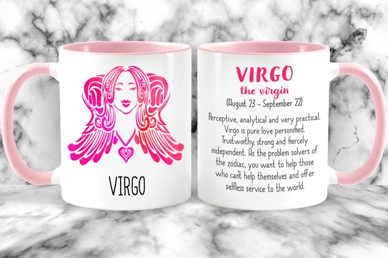 May include: White ceramic mug with a pink rim and handle. The mug features a pink and white illustration of the Virgo zodiac sign with the text "VIRGO" below. The other side of the mug has the text "VIRGO the virgin (August 23 - September 22)" and a description of the Virgo personality.