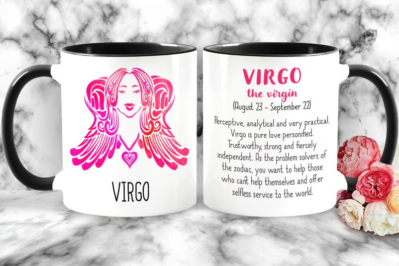 May include: White ceramic mug with a black handle. The mug features a pink and white illustration of a Virgo zodiac sign with the text "VIRGO" below. The other side of the mug has the text "VIRGO the virgin (August 23 - September 22)" and a description of the Virgo zodiac sign.