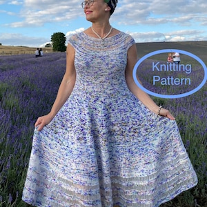 May include: A woman wearing a white and blue knit dress with a floral pattern, standing in a field of lavender. The dress has a scoop neck and cap sleeves. The woman is wearing a headband and glasses. The text "Knitting Pattern" is visible in a blue circle.