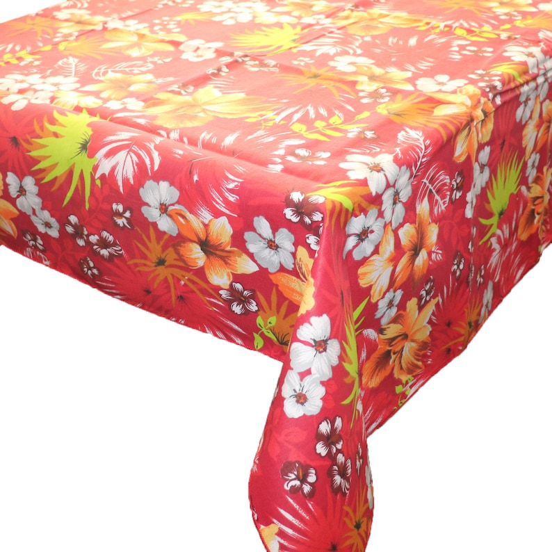May include: Red tablecloth with a tropical floral print featuring white, yellow, and green flowers and leaves.