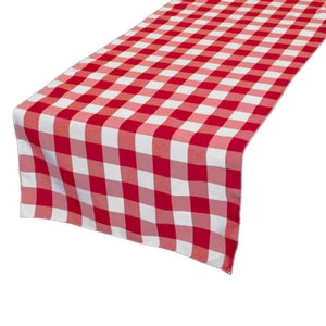 May include: A red and white checkered table runner. The runner is made of fabric and features a classic gingham pattern. The runner is angled, showing the pattern in detail.