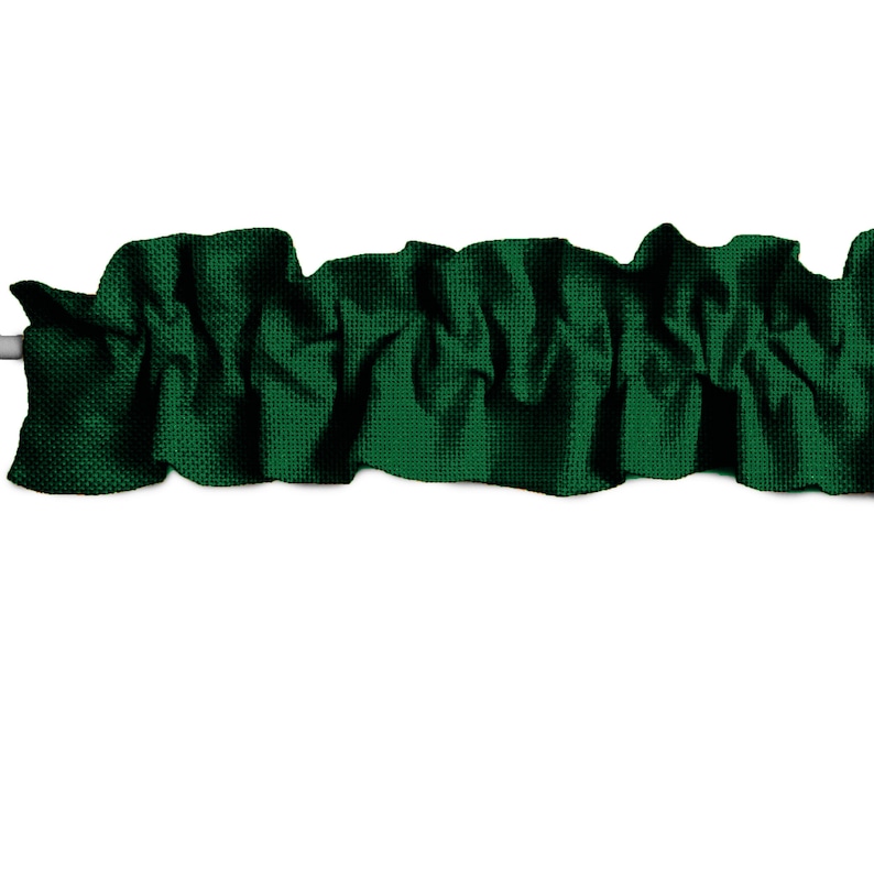 May include: A dark green fabric valance with a ruffled edge. The valance is made of a textured fabric and is perfect for adding a touch of elegance to any window.