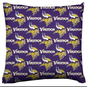 May include: Purple pillow with a repeating pattern of yellow Viking helmets and the word "Vikings" in white.