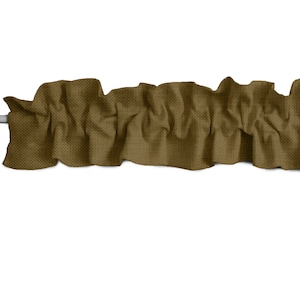 May include: A brown fabric valance with a ruffled edge. The valance is made of a textured fabric and has a casual, relaxed look.