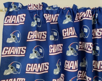 May include: Blue fabric with a repeated pattern of white "Giants" text and a blue and white football helmet with the letters "NY" on the side.