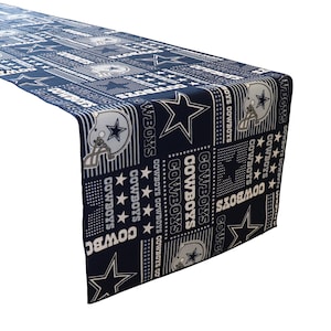 May include: A navy blue table runner featuring a white star and the word "COWBOYS" repeated in a pattern.