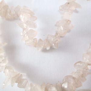 Bead, rose quartz, small chip, M1728
