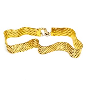 May include: A gold-toned chain belt with a woven, grid-like pattern. The belt has a clasp closure.