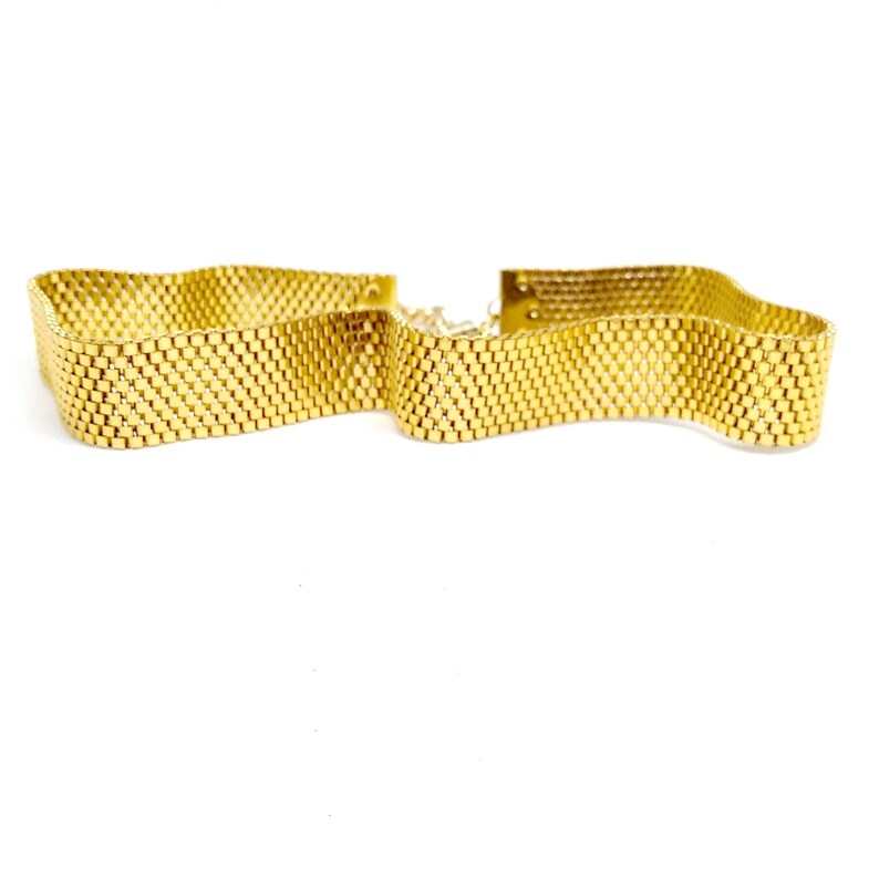 May include: A gold-toned metal choker necklace with a woven chain design.