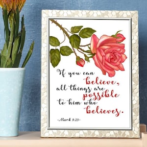May include: A white framed print with a pink rose and green leaves. The print features a quote from the Bible, Mark 9:23, which reads: "If you can believe, all things are possible to him who believes."