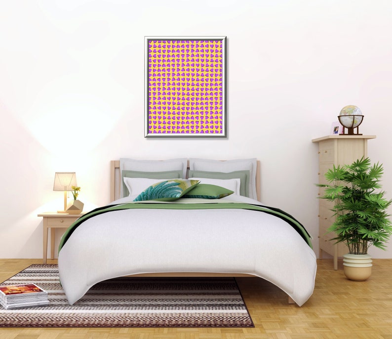May include: A white bed with a green and white patterned throw pillow and a framed print of a yellow and purple geometric pattern. The bed is in a bedroom with a wooden nightstand, a potted plant, and a wooden dresser with a globe on top.