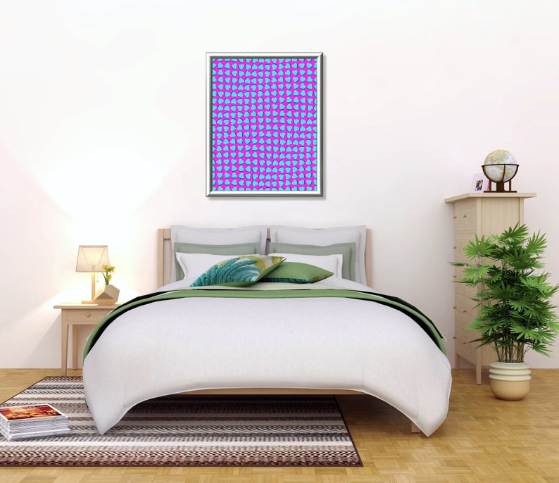 May include: A white bed with a green and white patterned bedspread and two pillows. A framed print with a blue and pink geometric pattern hangs above the bed. A lamp sits on a wooden nightstand next to the bed. A potted plant and a globe sit on a wooden dresser to the right of the bed.