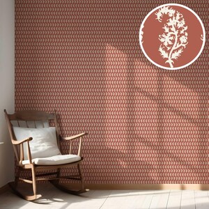 May include: A room with red wallpaper featuring a repeating paisley pattern. A wooden rocking chair with a white cushion sits in the corner. A circular inset shows a white floral design on a red background.