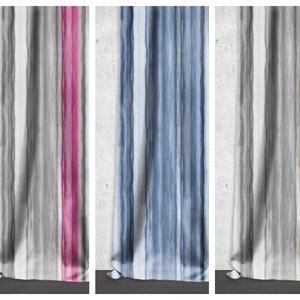 May include: Three fabric samples with a white background and vertical stripes in different colors. The first sample has gray stripes with a pink stripe on the right side. The second sample has blue stripes. The third sample has gray stripes with a gold stripe on the right side.