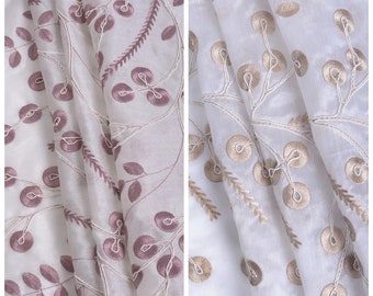 May include: Two pieces of sheer white fabric with embroidered floral designs. One fabric has pink embroidery and the other has gold embroidery.
