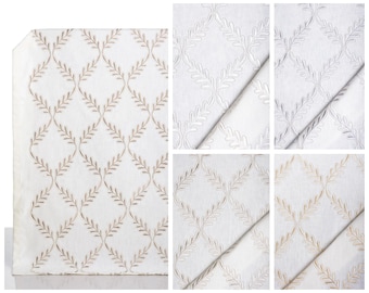 May include: White fabric with an embroidered leaf pattern in various colors, including beige, silver, and gold. The design features a repeating diamond trellis with stylized leaves. The fabric is shown in multiple swatches.