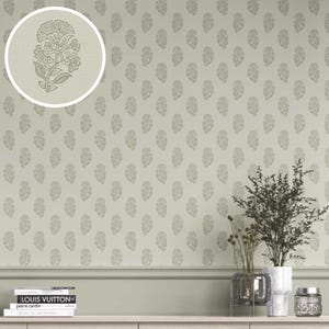 May include: A light green wallpaper with a repeating floral pattern. A close-up shows a detailed floral design. The wallpaper is displayed with decorative items, including books, vases, and a small jar, creating a stylish interior design.