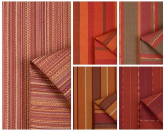 May include: Close-up of six different fabric swatches with various striped patterns in shades of red, orange, brown, and beige.