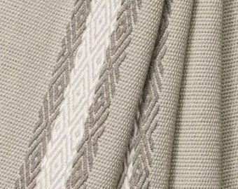 May include: Close-up of a woven throw blanket with a white and gray geometric pattern. The blanket is made of a soft, textured fabric.