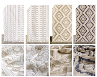 May include: A collection of fabric swatches featuring geometric patterns in shades of beige, gray, and blue. The patterns include diamonds, stripes, and zigzags.