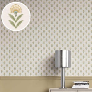 May include: Cream-colored wallpaper with a repeating pattern of small yellow and green floral motifs. A circular inset shows a detailed illustration of a single flower. A silver lamp and books are visible on a white surface.