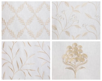 May include: Four different fabric swatches with embroidered floral patterns in gold thread on a white background.