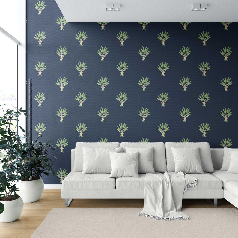 May include: A modern living room featuring a white sectional sofa, a beige rug, and potted plants. The navy blue wall is adorned with a repeating pattern of green and gold stylized plant motifs, creating a stylish backdrop.