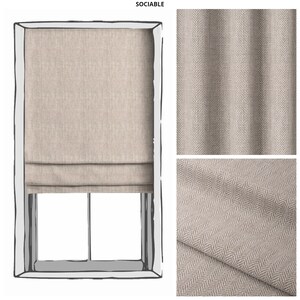 May include: A beige roman shade with a herringbone pattern. The shade is shown in a window with a white frame. The fabric is shown in two close-up images.