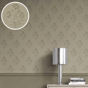 May include: Wallpaper with a repeating floral pattern in a neutral colour scheme. The design features stylized flowers and leaves in a lighter shade against a muted background. A silver lamp and books are visible, suggesting interior decor.