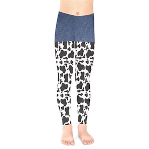 May include: Black and white cow print leggings with a denim waistband.