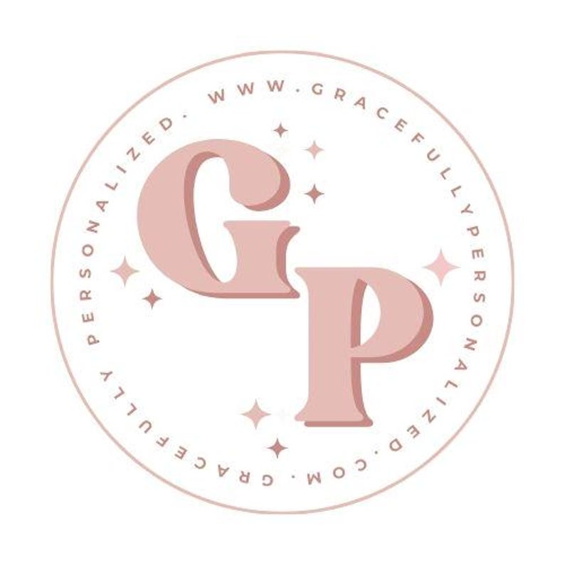 May include: A circular logo featuring the large, dusty pink letters G and P in the center. The text WWW.GRACEFULLYPERSONALIZED.COM is written in a circular border around the letters. Small four-pointed star icons are scattered around the letters.